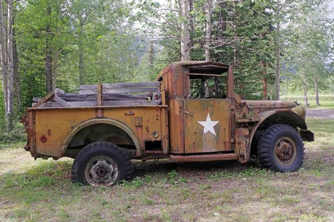 Side view of a rusty military vehicle with star in the forest, former army camp, Yukon, Discovery