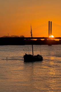 Sunset over river Rhine Lower Rhine, on the left in the foreground anchored historical ship