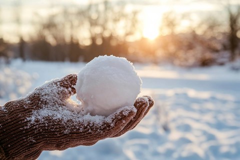 Hand in knitted glove holding snowball. Generative Ai, AI generated