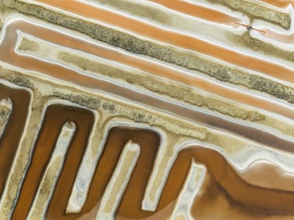 Saline ponds at the salt works near Chiclana de la Frontera. The orange-red colour depends on the