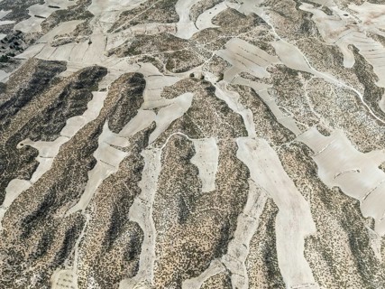 Farmland amongst rocky outcrops. Aerial view. Drone shot. Granada province, Andalusia, Spain,