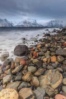 Stones, coast, sea, waves, mountains, winter, snow, cloudy, windy, long exposure, Lyngen Alps,