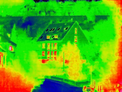 Apartment block, facade of a residential building with windows. Thermal image or thermography,
