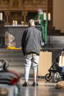 A mentally confused homeless man in the church, family mass with blessing of animals in St Agnes,