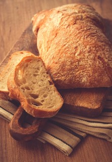 Sliced ciabatta, on a chopping board, italian bread, close-up, Italian cuisine, breakfast, no