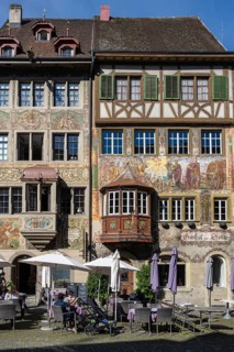 Imposing, historic half-timbered buildings with detailed facade paintings on the market square in