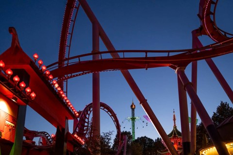 Roller coaster, chain carousel and pagoda at night, Tivoli Amusement and Recreation Park,