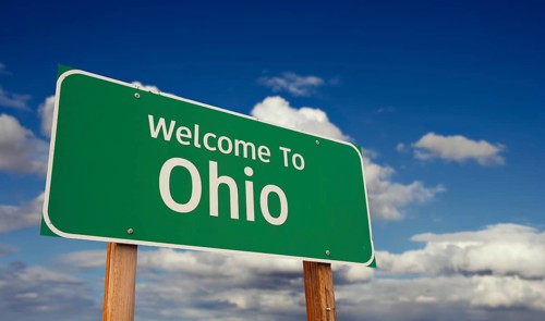 Welcome to ohio green road sign over blue sky with some clouds