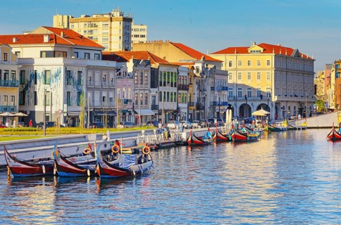 View of moliceiro boats floating on Aveiro river main lagoon, Aveiro, Portugal, Europe