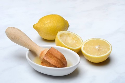 Lemons and lemon squeezer, squeezed lemon and lemon juice