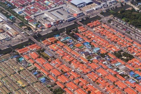 Retort city in the north-east of Bangkok. Standardised houses stand close together on the straight