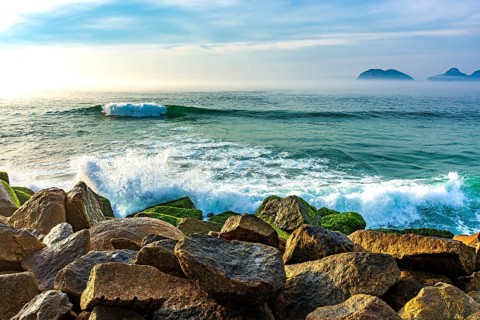 Waves crashing against the breakwater at Barra da Tijuca beach in Rio de Janeiro at dawn Rio de