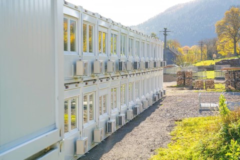 Rows of containers with air coolers in a sunny landscape, Beermiß refugee accommodation centre,