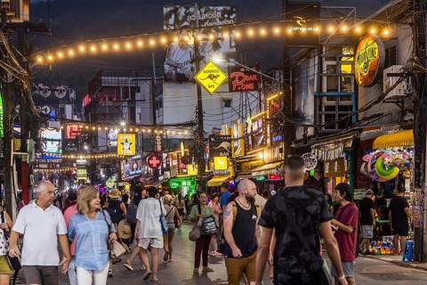 Crowds of people on Bangla Street in the evening. Nightlife on Bangla Walking Street with go-go