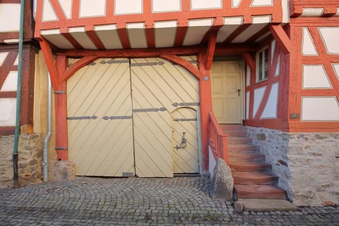 Entrance with gate and stairs to the red half-timbered house, house entrance, red, beams,