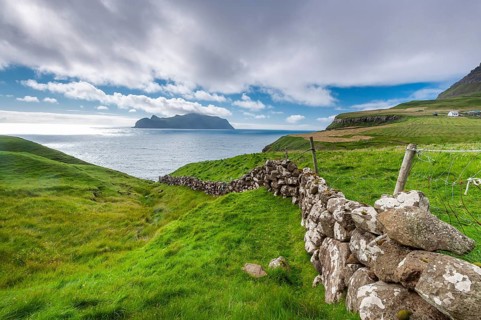 View of the island of Mykines, old stone wall, Gásadalur village, Vágar, Faroe Islands, Denmark,