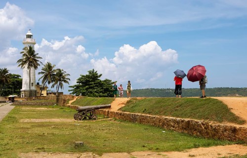 Visitors on the causeway to Galle Lighthouse at Dutch Fort, Galle, Southern Province, Sri Lanka,