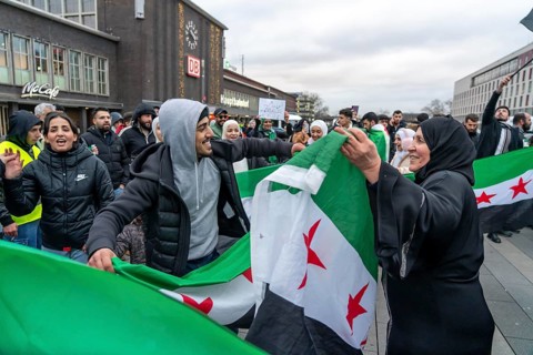 Syrian woman celebrate the end of the Assad regime after the change of power in Syria at a rally on