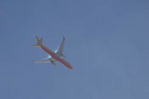 Boeing 767 jet aircraft of DHL airlines flying in a blue sky, England, United Kingdom, Europe