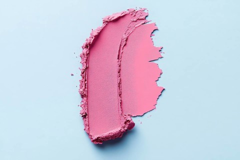 Pink lipstick color swatch smudge on light blue background. Generative Ai, AI generated
