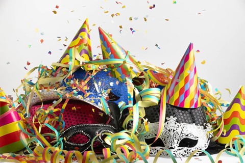 Colourful party hats with confetti and streamers in a lively party setting, carnival