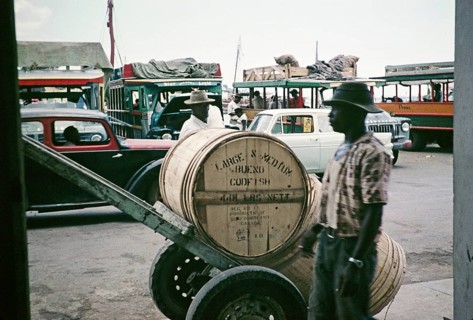 Bues and cars at the harbour, wooden barrels of codfish in foreground, Castries, St Lucia, West