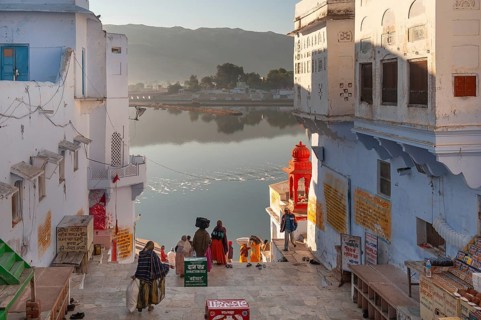 Morning atmosphere, people walking down to the lake shore, old town of Pushkar at the holy Pushkar