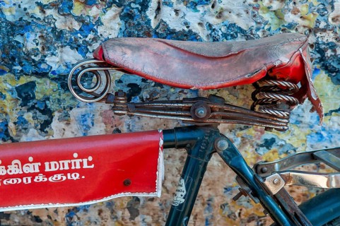 Red bicycle saddle, bicycle in front of blue-yellow wall, Karaikkudi, Tamil Nadu, India, Asia