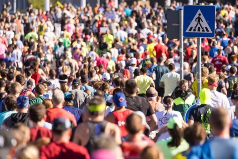 Runner next to a pedestrian crossing sign at the 50th BMW Berlin Marathon 2024 on 29/09/2024