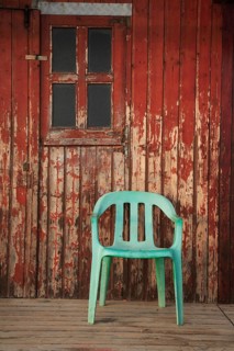 Plastic chair, old fishermen's huts in Armacao de Pera, Algarve, Portugal, Europe
