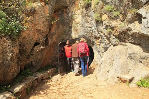 People entering the cave entrance, Cueva de la Pileta, near Ronda, Malaga province, southern Spain