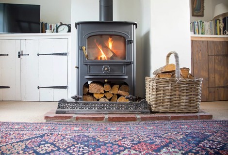 Warm fire flames logs burning in ClearView domestic multifuel stove burner inside home, UK