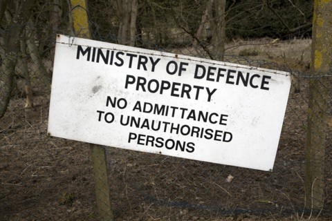 Ministry of Defence property sign No admittance to unauthorised persons on fence, Bawdsey, Suffolk,