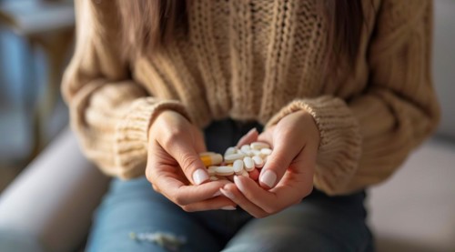 Woman with painkillers suffering for menstrual or stomach pain or other sickness. Overmedication,