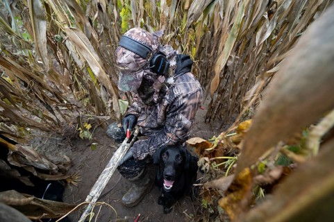 Hunter loads his self-loading shotgun in the umbrella