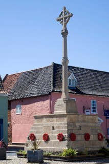 War memorial and historic buildings in the town of Holt, north Norfolk, England, United Kingdom,