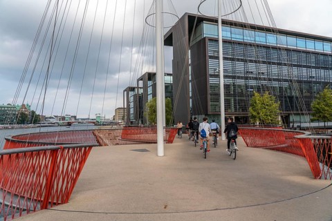 Cyclists on the Cirkelbroen cycle and pedestrian bridge, over the harbour, in the Christianshavens