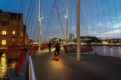 Cyclists on the Cirkelbroen cycle and pedestrian bridge, over the harbour, in the Christianshavens