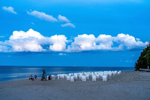Beach in the evening, with thick storm clouds, near Sellin, beach chairs, island of Rügen,