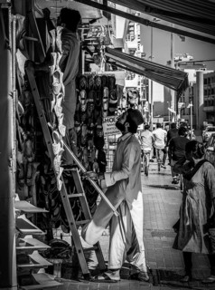 Black and white photography, shoe shops and craftsmen in Al Fahidi neighbourhood, Dubai, United