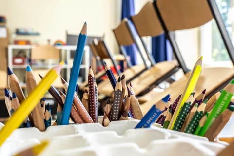 Classroom of a fourth grade, after school, the building is older but in good condition, coloured
