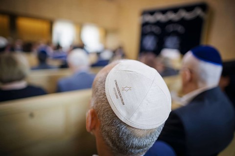 A man with a kippah sits in the synagogue during the inauguration of the synagogue centre in