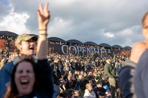 Copenhagen, Denmark - 19 June 2024: Festivalgoers in front of the logo at the Copenhell Metal