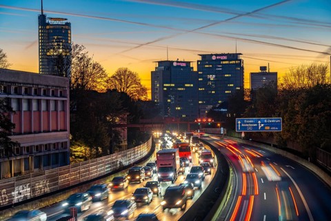 Evening traffic, partly with traffic jams, slow-moving traffic on the A40 motorway, skyline of
