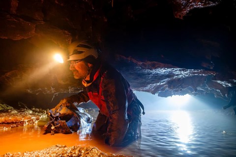Speleologist crosses an underground lake, Advent Cave, Schneizlreuth, Berchtesgadener Land, Upper