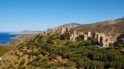 Historic village on a mountain near the coast with clear skies, Vathia, residential tower village,