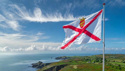 The flag of the Isle of Jersey, Great Britain flutters in the wind