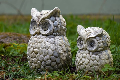 Two eagle owl figures in the garden, Bavaria, Germany, Europe