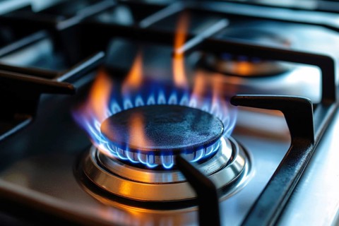 Close up of blue flames burning on gas oven. Generative Ai, AI generated