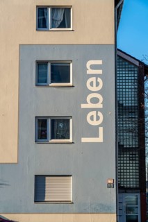 Residential buildings, rented flat, façade with the inscription Leben, on Adolf-Schmidt-Strasse,